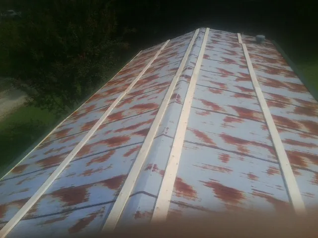 Rusted metal roof panels with new wood purlins before replacement — Storm Damage Roof Repair in Thatcher by Roofing Brothers